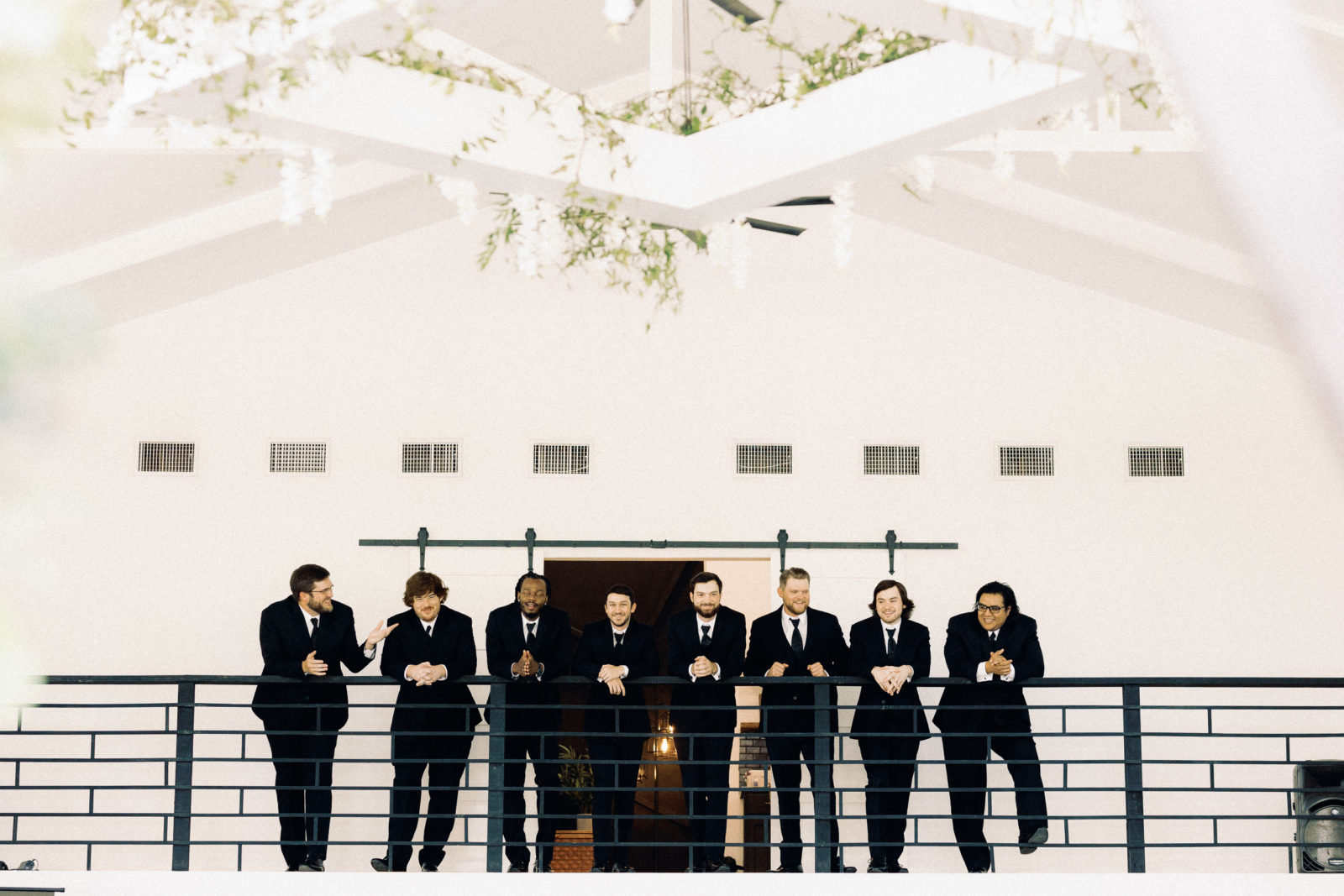 groom and groomsmen in timeless black suits
