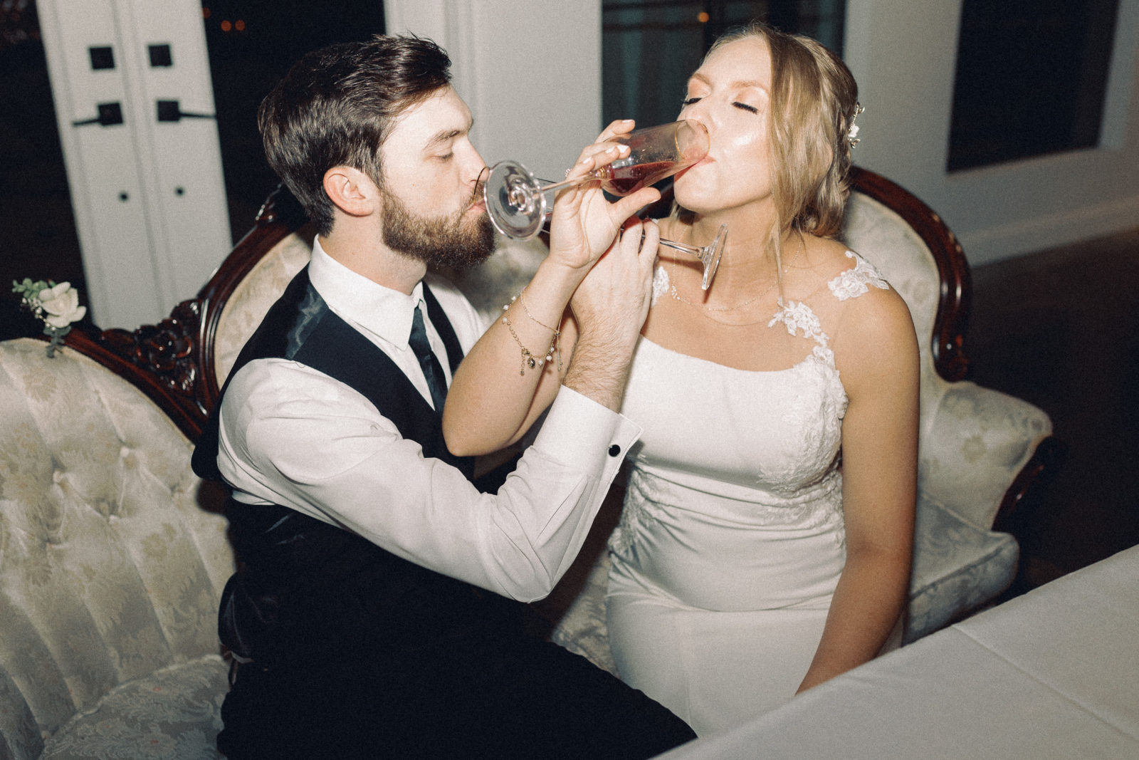 bride and groom sipping champagne