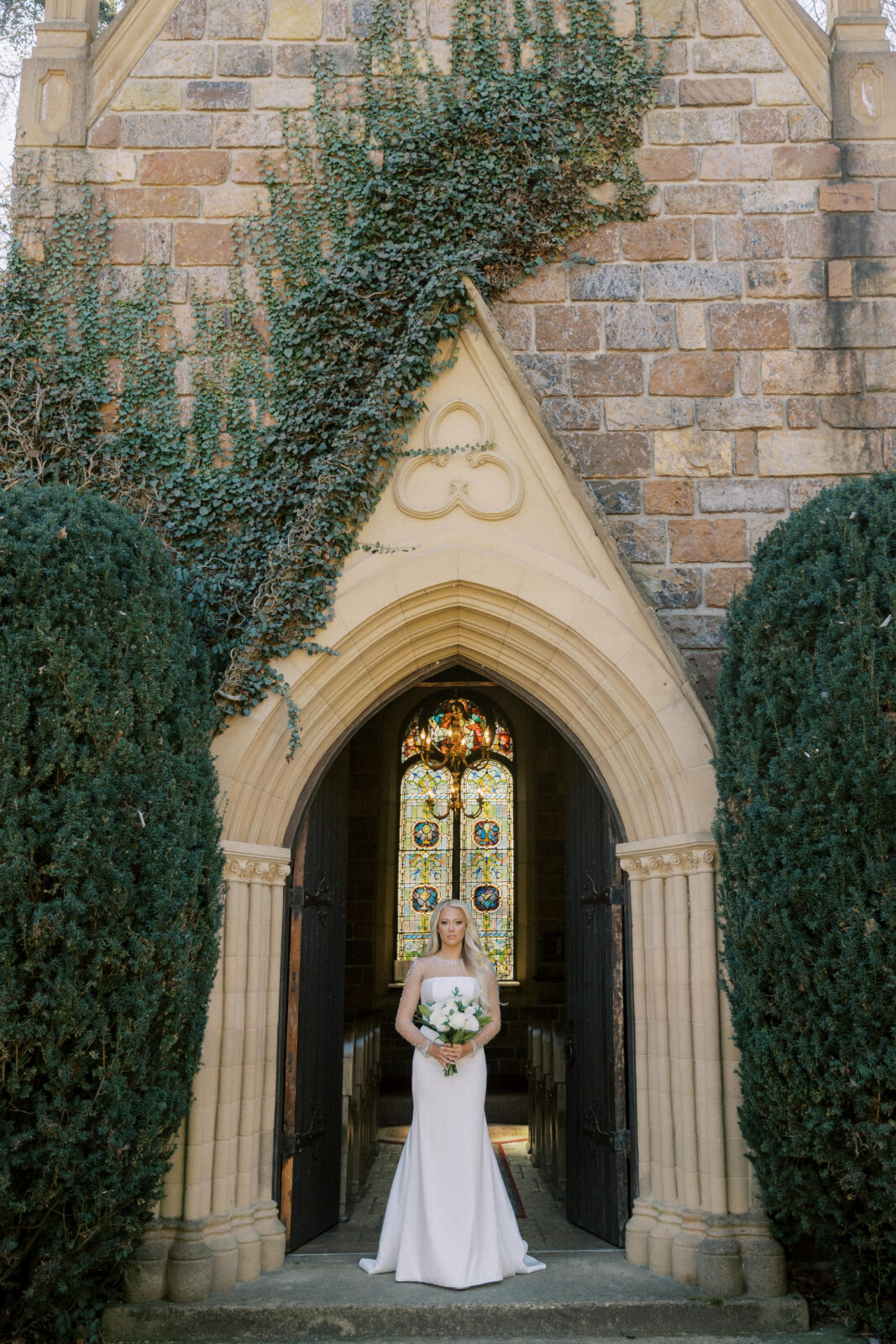 Grace posing in her wedding gown at St. Catherine’s at Bell Gable in Fayetteville, Arkansas