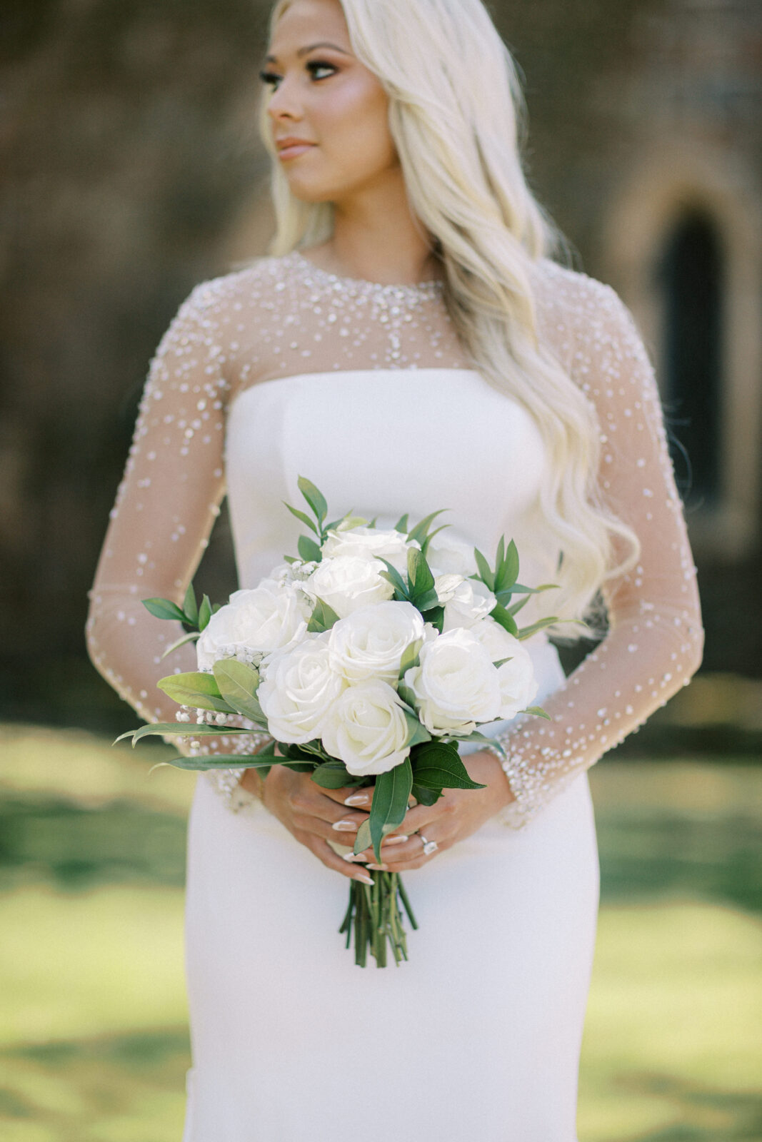 Bride standing outside the stone chapel at St. Catherine’s at Bell Gable