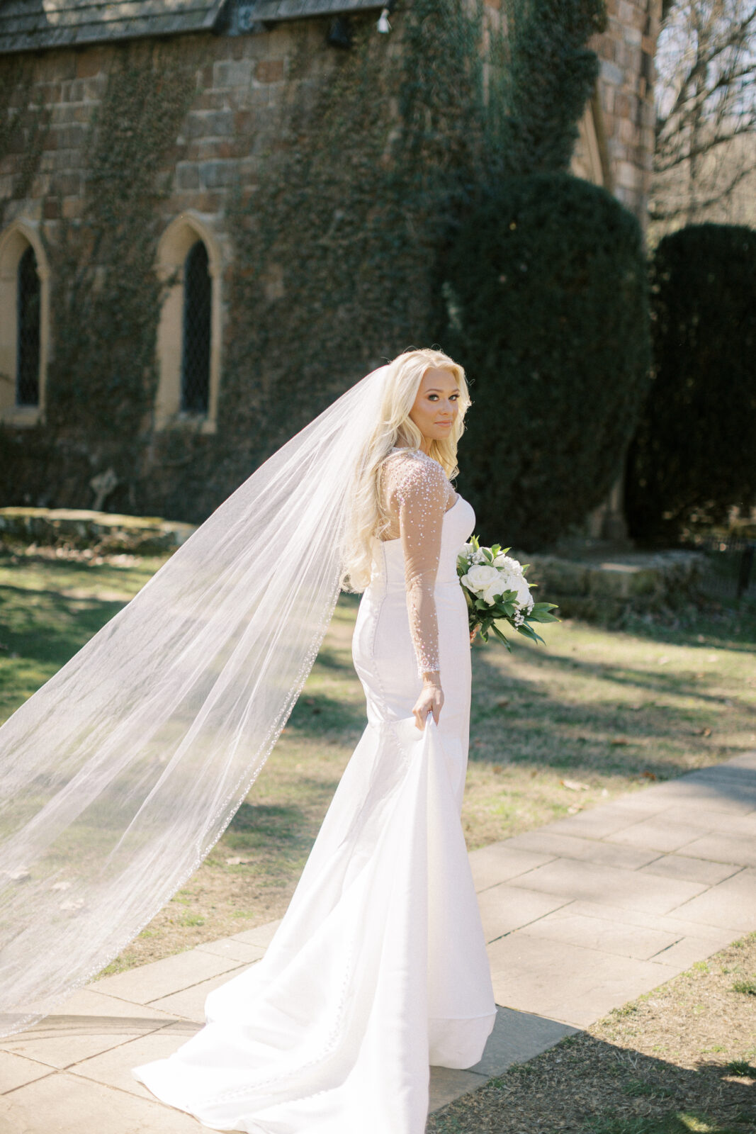 Grace posing in her wedding gown at St. Catherine’s at Bell Gable in Fayetteville, Arkansas