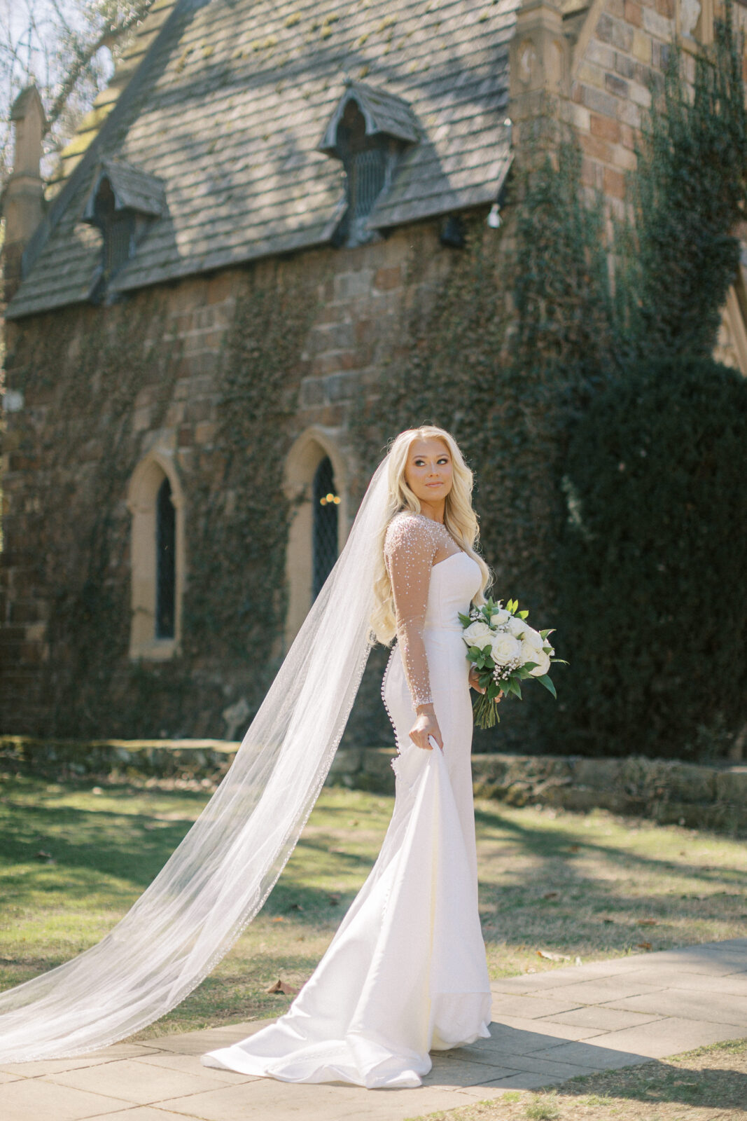 Grace posing in her wedding gown at St. Catherine’s at Bell Gable in Fayetteville, Arkansas