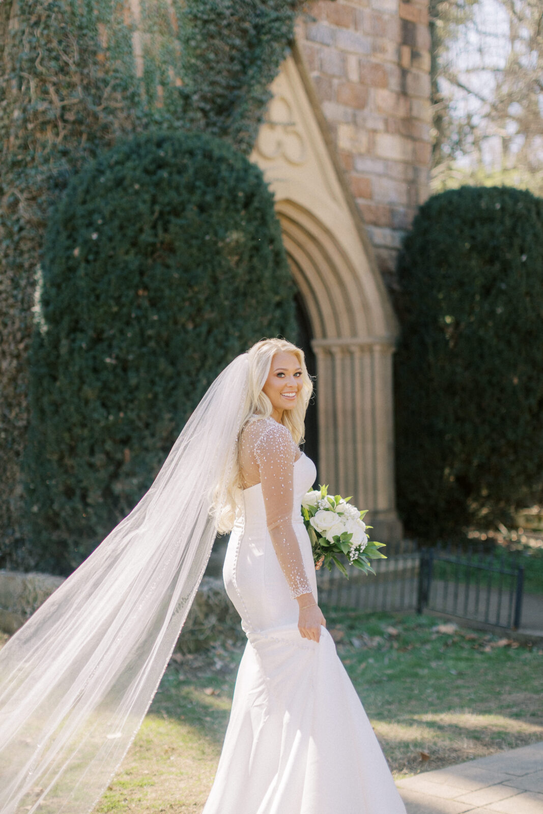 Bride standing outside the stone chapel at St. Catherine’s at Bell Gable