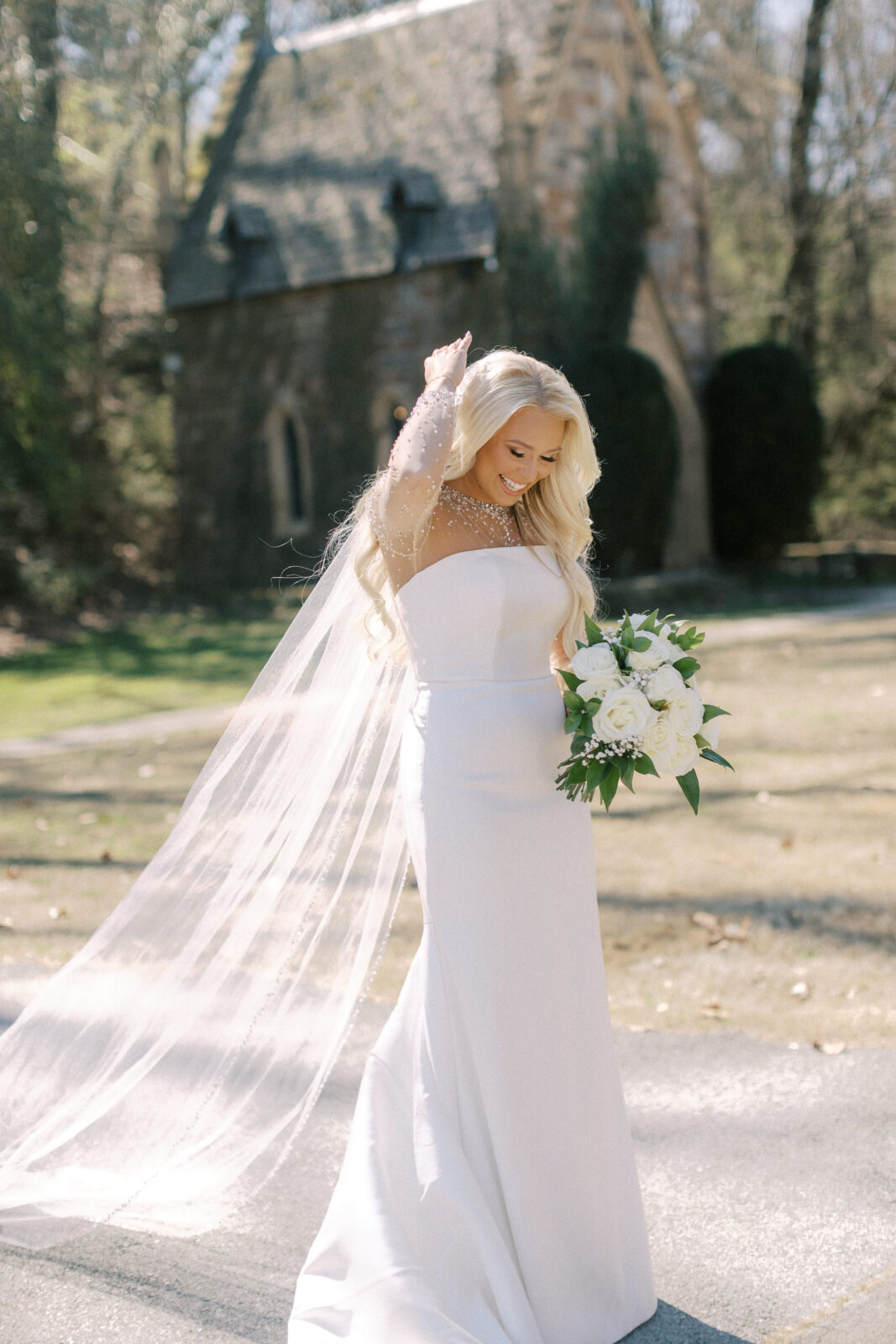 Bride standing outside the stone chapel at St. Catherine’s at Bell Gable