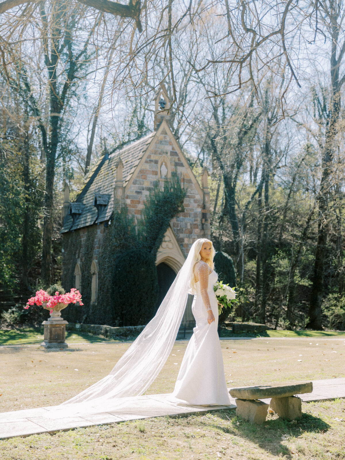 Bride standing outside the stone chapel at St. Catherine’s at Bell Gable