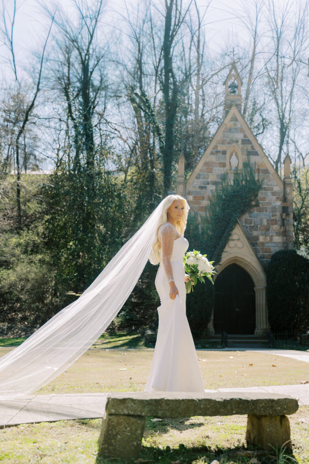 Bride standing outside the stone chapel at St. Catherine’s at Bell Gable