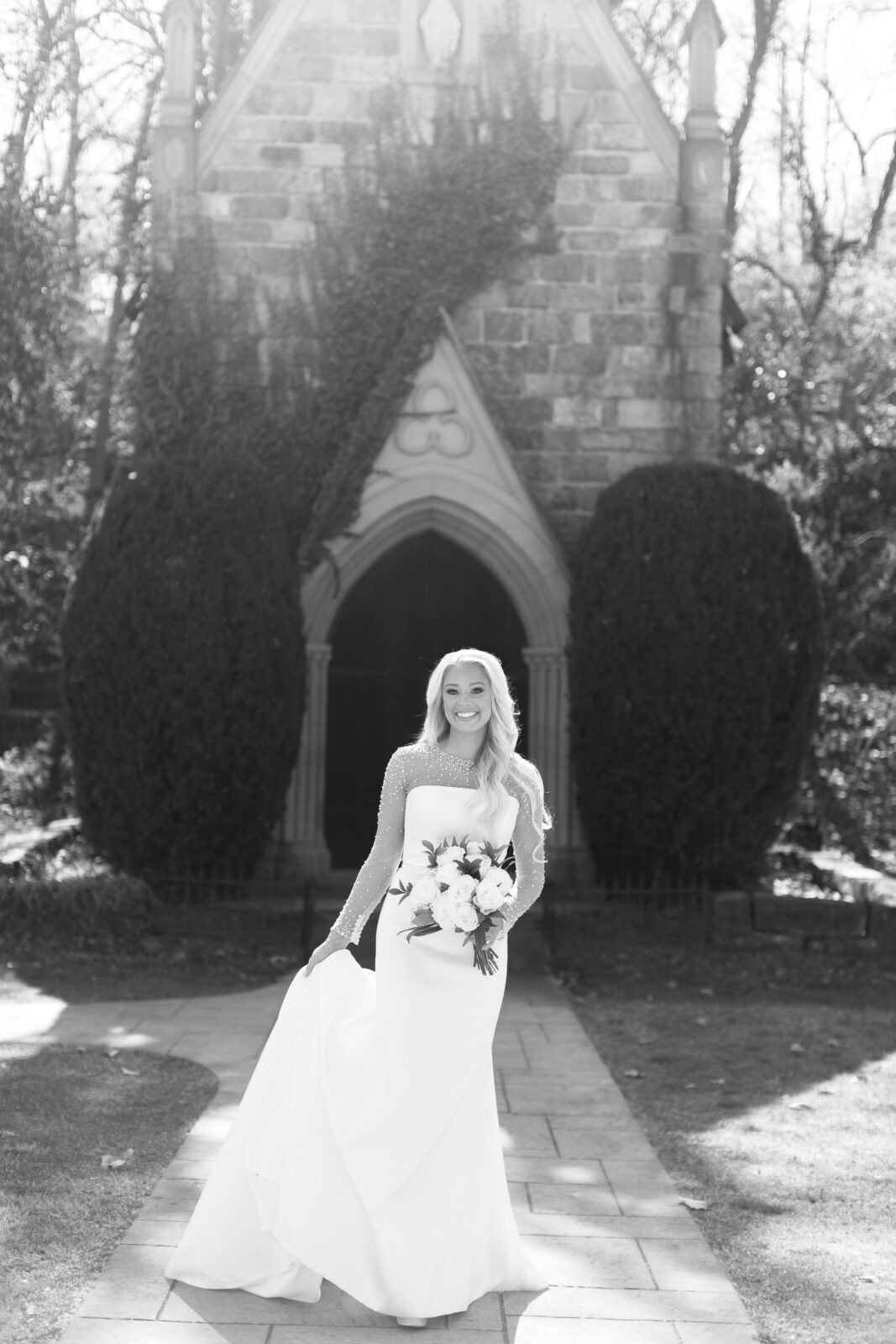 Bride standing outside the stone chapel at St. Catherine’s at Bell Gable