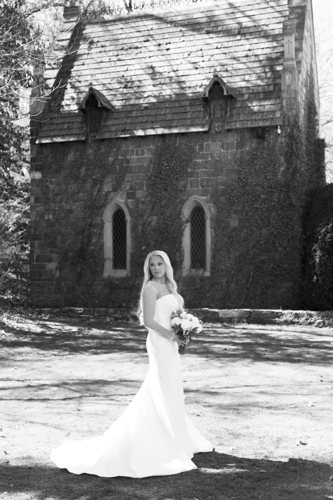 Bride standing outside the stone chapel at St. Catherine’s at Bell Gable