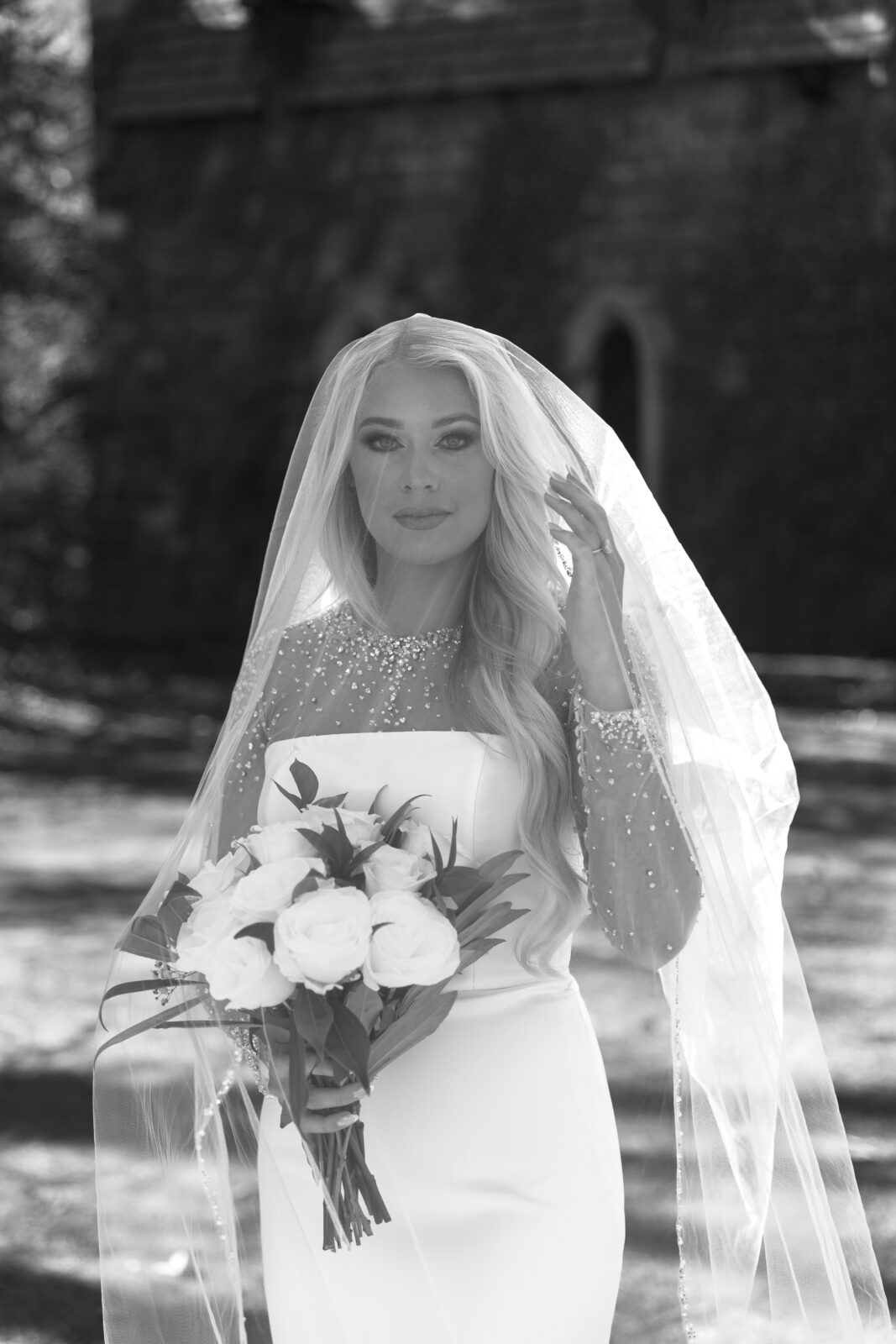 Bride standing outside the stone chapel at St. Catherine’s at Bell Gable